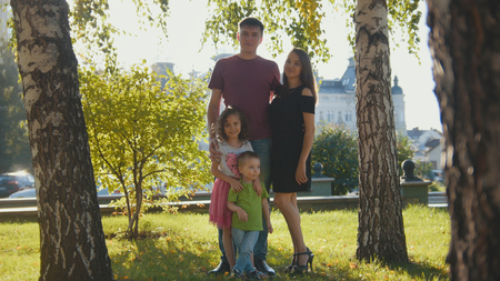 Family in summer park at sunset -Father, mother and childrenの写真素材