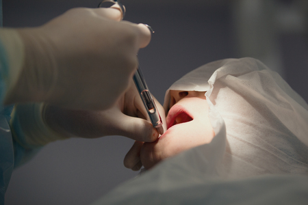 Doctor dentist performs a procedure anesthesia before stomatology surgeryの写真素材