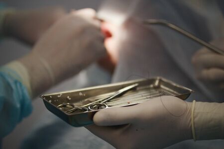Doctor dentist performs a procedure local anesthesia during stomatology surgery