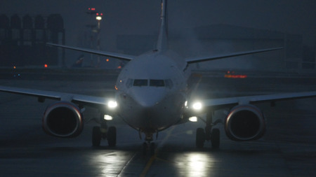 Modern jet airplane in Airport at duskの写真素材
