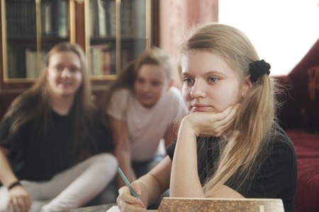 Girls teenagers plays and prevent to do lessonsの写真素材