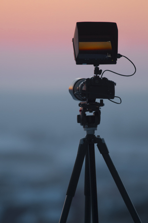 View of camera on tripod shooting beautiful winter landscapeの写真素材