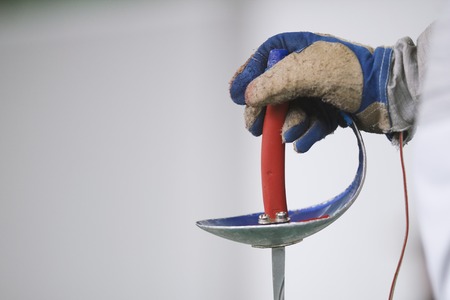 Gloved hand of the fencer holds the foilの写真素材