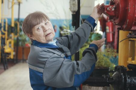 Portrait of a elderly woman - worker - senior Technician on manufacturing siteの写真素材