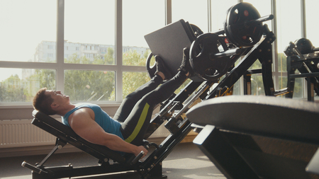 Young bodybuilder on the strength training in a gym