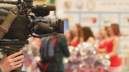 Camera in front of girls cheerleaders at the karate championshipの写真素材