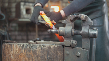 The blacksmith manually forging in the smithyの写真素材