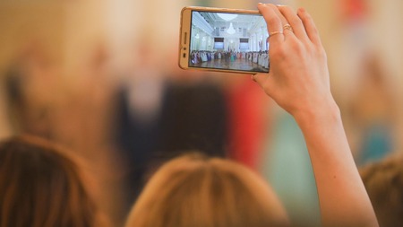 Woman shoots on the smartphone dancing at the historical ballの写真素材