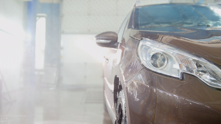 Car in the car wash, washed fender and headlightsの写真素材