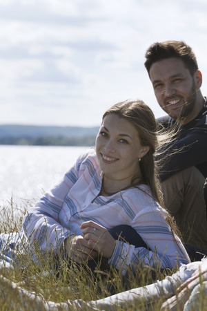 Young happy woman and man enjoying recreation together outdoorsの写真素材