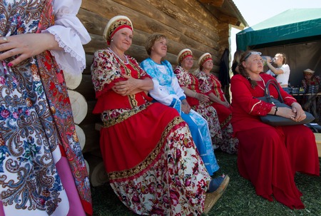KAZAN, RUSSIA - JUNE 23, 2018: Traditional Tatar festival Sabantuy - Mature women artists in russian national dresses sitting on the benchのeditorial素材