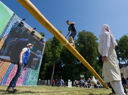 KAZAN, RUSSIA - JUNE 23, 2018: Traditional Tatar festival Sabantuy - A young man walking on the balance beam at sunny dayのeditorial素材