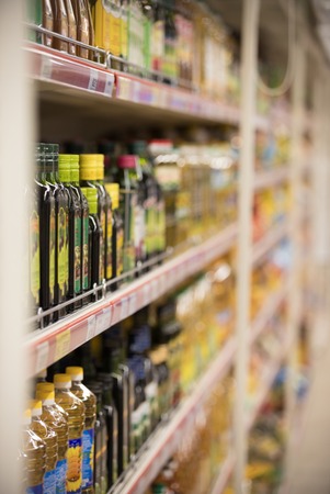 Blur Supermarket sale oil bottles on shelves background, Many cooking oil bottles sale on the shelf...