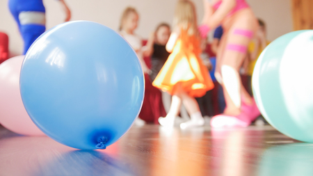 Blue balloon and group of kids on the backgroundの写真素材