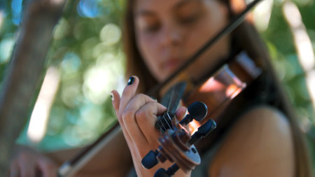 Young girl playing the vintage violin on the natureの写真素材