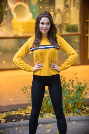 Outdoor fashion photo of beautiful young woman