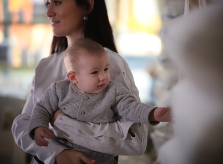 Young happy family on shopping. Mother holding a baby. Focus on baby