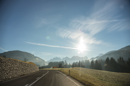 Travel by car in the mountains. A view from the car on the road. Sunny dayの写真素材
