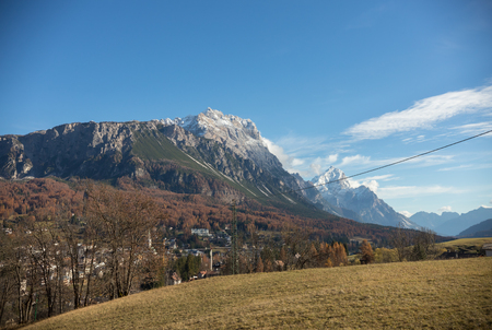 Traveling. A beautiful landscape. Alpine mountains, forest and yellow field.の写真素材