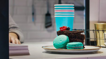 Blue macaroons on the check out waiting for the customerの写真素材