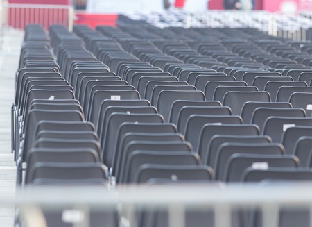 Rows of empty dark chairs. Abstract. Front viewの写真素材