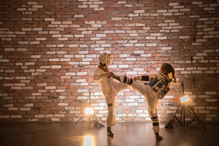 Two little girls training their karate skills. Attack and defense
