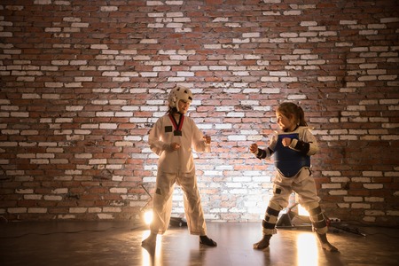 Two little girls training their karate skills. Standing in the position