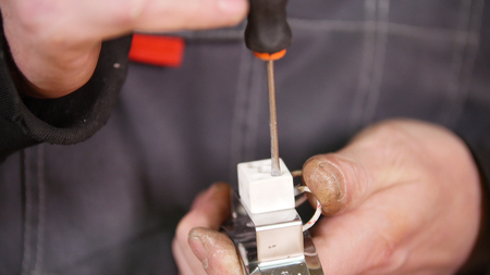 Industrial concept. A worker making the detail work. Mid shot