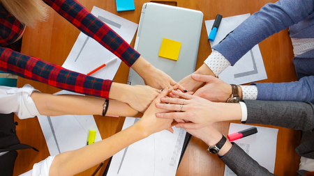 Business concept. A working team put their hands together