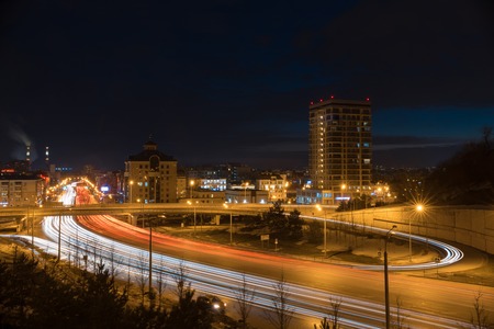A city lights and cars riding on the road. Modern buildings in night lights.の写真素材