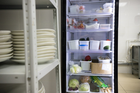 Restaurant kitchen. An opened fridge with products. Mid shotの写真素材
