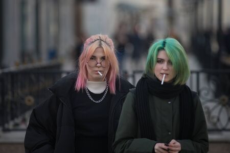 RUSSIA, KAZAN 10-04-2019: Urban streets. Two young women with colorful hair standing on the streetのeditorial素材