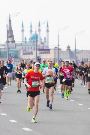 05-05-2019 RUSSIA, KAZAN: Running marathon in the city. People jogging on the road on a background of Kazan Kremlinのeditorial素材