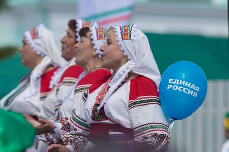 RUSSIA, Nikolskoe village, Republic of Tatarstan 25-05-2019: A group of mature women dancing traditional dance. A balloon with a name of Political Party United Russiaのeditorial素材