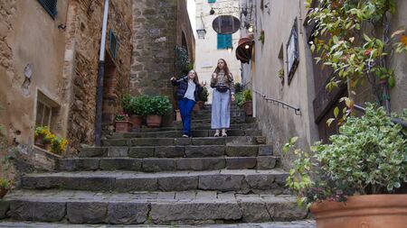 Women walk down the stairs - Drink coffee and look aroundの写真素材
