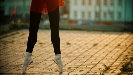 Young woman ballerina standing on her tiptoesの写真素材