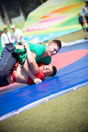 REPUBLIC OF TATARSTAN, RUSSIA: 04.07.2019 - Two fat men are fighting at Sabantui competitions.