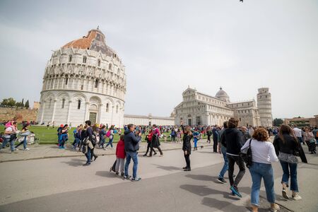 ITALY, PISA 22-04-2019: tourists walking near the sights and lying on the grassのeditorial素材