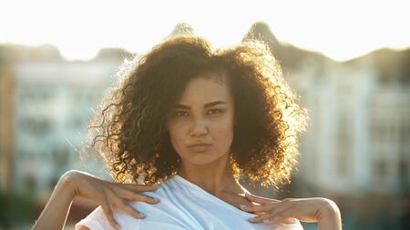 Young attractive woman mixed race looking in the camera - sunsetの写真素材