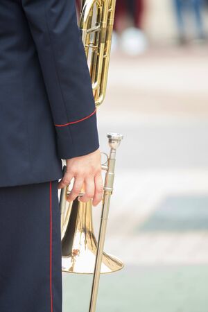 A wind instrument parade - a man holding a trumpet