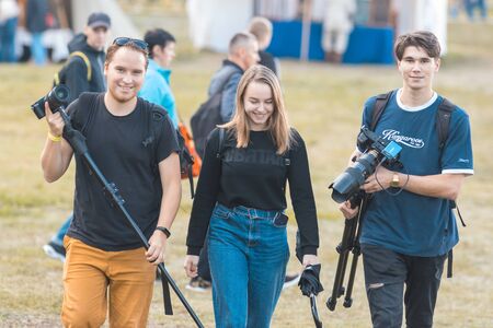 BULGAR, RUSSIA 11-08-2019: A photographer team of two men and woman walking on the medieval festival and carrying the equipmentのeditorial素材