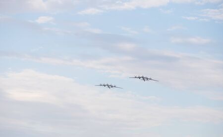 Two military long range bomber aircrafts flying in the cloudy skyの写真素材