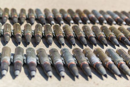 A row of ammunition cartridges - row of bullets. Mid shot