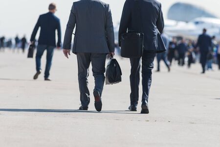 Business people walking down the street talkingの写真素材