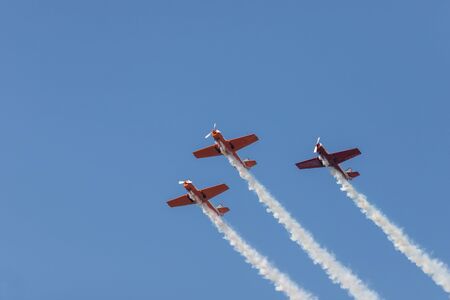Three colorful jets flying in the sky and performing a show