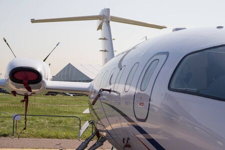 An outdoors airplane exposition - an airplane with strange big things on the wing
