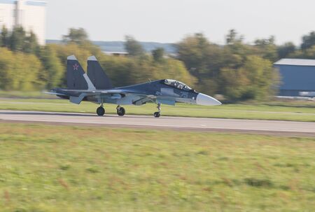 Reactive fighter jet is gaining speed on the runway