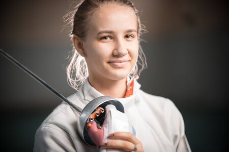 A portrait of a young woman fencer