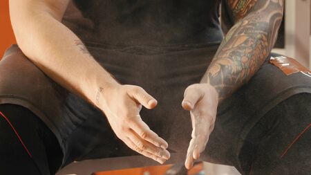 Athlete rolling his hands in talcum powderの写真素材
