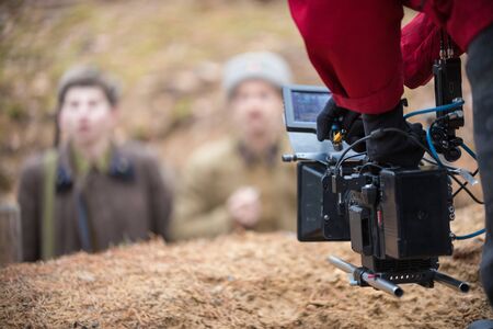 A man with camera in hand is filming the actorsの写真素材